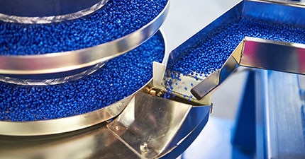 blue pellets in a machine